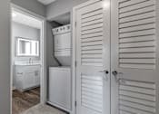 Thumbnail 50 of 53 - a white bathroom with a closet and a sink