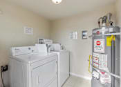 Thumbnail 37 of 38 - A wall-mounted washing machine with a yellow caution tape around it.