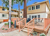 Thumbnail 35 of 62 - A small building with a brown and beige exterior is surrounded by a wooden fence.