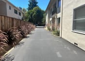 Thumbnail 5 of 19 - a paved street with a building on both sides of it