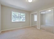 Thumbnail 26 of 34 - A room with a window and a sliding door.