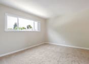 Thumbnail 14 of 37 - A room with a window and carpeted floor.