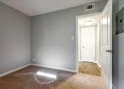 Thumbnail 25 of 35 - A room with a carpeted floor and a white door.