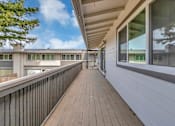 Thumbnail 16 of 53 - a long balcony with a wood floor and a large window