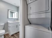 Thumbnail 49 of 53 - a white bathroom with a refrigerator and a sink