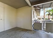 Thumbnail 9 of 33 - A room with a bicycle leaning against the wall.