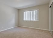 Thumbnail 32 of 34 - A room with a window covered by white blinds.