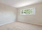 Thumbnail 13 of 37 - A room with a window and carpeted floor.