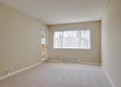 Thumbnail 15 of 33 - an empty living room with a large window