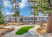 Thumbnail 4 of 53 - a courtyard with benches and trees in front of an apartment building