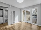 Thumbnail 13 of 31 - A room with a white wall and a window with a view of a house.