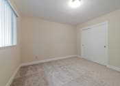 Thumbnail 26 of 29 - A room with a carpeted floor and a white door.