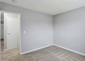 Thumbnail 17 of 55 - A room with a carpeted floor and a white door.