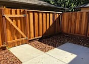 Thumbnail 21 of 47 - A wooden fence with a gate in the middle.