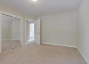 Thumbnail 31 of 34 - A room with a sliding glass door and carpeted floor.
