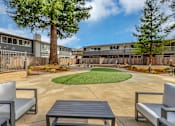 Thumbnail 5 of 53 - A paved courtyard area with landscaping and outdoor furniture