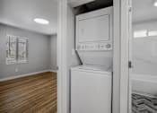 Thumbnail 14 of 31 - A white dishwasher is in a kitchen with wood flooring.