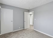 Thumbnail 55 of 55 - A room with a carpeted floor and two doors.