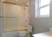 Thumbnail 3 of 29 - a white bathroom with a shower and a toilet