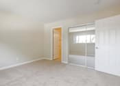 Thumbnail 11 of 37 - A room with a white door and a window with blinds.