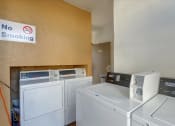 Thumbnail 32 of 35 - A laundry room with a no smoking sign on the wall.