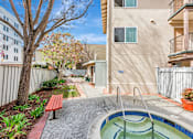 Thumbnail 24 of 42 - A small pool in a courtyard surrounded by a fence.