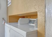 Thumbnail 33 of 35 - A washing machine in a small room with a no smoking sign on the wall.