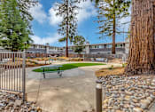 Thumbnail 7 of 53 - a community park with a picnic table and benches in front of a building