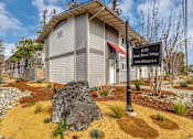 Thumbnail 1 of 53 - a building with a sign and a rock in front of it