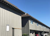 Thumbnail 23 of 30 - the side of a building with a brown roof