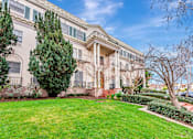 Thumbnail 16 of 42 - A large, well-maintained lawn in front of a two-story building with a balcony.