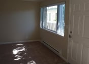 Thumbnail 8 of 31 - an empty living room with a window and a door