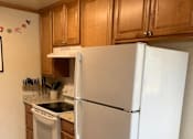 Thumbnail 30 of 32 - a kitchen with a white refrigerator and a stove