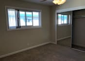 Thumbnail 39 of 62 - a living room with a mirrored closet and two windows