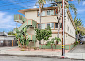 Thumbnail 13 of 14 - A house with a green staircase on the side.