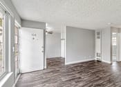 Thumbnail 29 of 40 - A room with wood flooring and a ceiling fan.