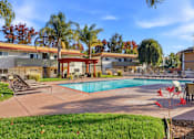 Thumbnail 40 of 67 - A pool surrounded by a patio and trees.