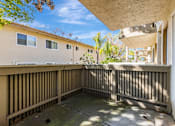 Thumbnail 25 of 51 - A balcony with a wooden railing and a concrete floor.