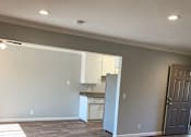 Thumbnail 11 of 37 - A kitchen area with a refrigerator and a door.