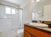 Thumbnail 9 of 37 - A bathroom with a toilet, sink, and shower.
