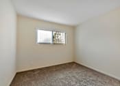 Thumbnail 32 of 43 - A room with a window and carpeted floor.
