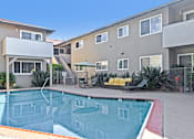 Thumbnail 9 of 37 - A swimming pool in front of apartment buildings.