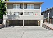 Thumbnail 6 of 32 - A two-story residential building with a garage.