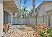 Thumbnail 13 of 37 - A house with a patio and a fence.
