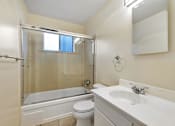 Thumbnail 15 of 43 - A white bathroom with a toilet, sink, and bathtub.