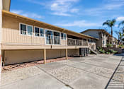 Thumbnail 40 of 51 - A sunny day at a residential complex with a clear blue sky.