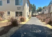 Thumbnail 3 of 19 - a sidewalk in front of an apartment building