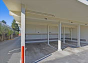Thumbnail 35 of 35 - A parking garage with a white ceiling and concrete floor.