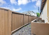 Thumbnail 6 of 38 - A wooden fence runs along the side of a house.