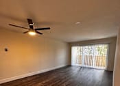 Thumbnail 1 of 32 - an empty living room with a ceiling fan